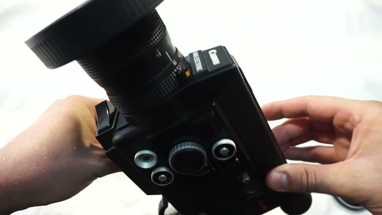 Canon 814 XL loading Super 8 film and batteries on Super 8 camera
