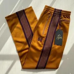 2026年最新】needles トラックパンツ マスタードの人気アイテム - メルカリ